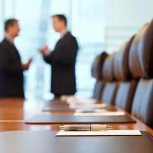 2 people talking at a conference table