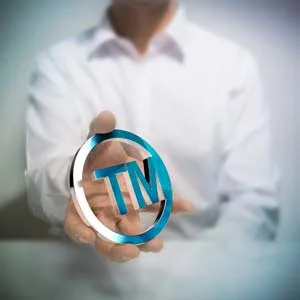 person holding trademark symbol
